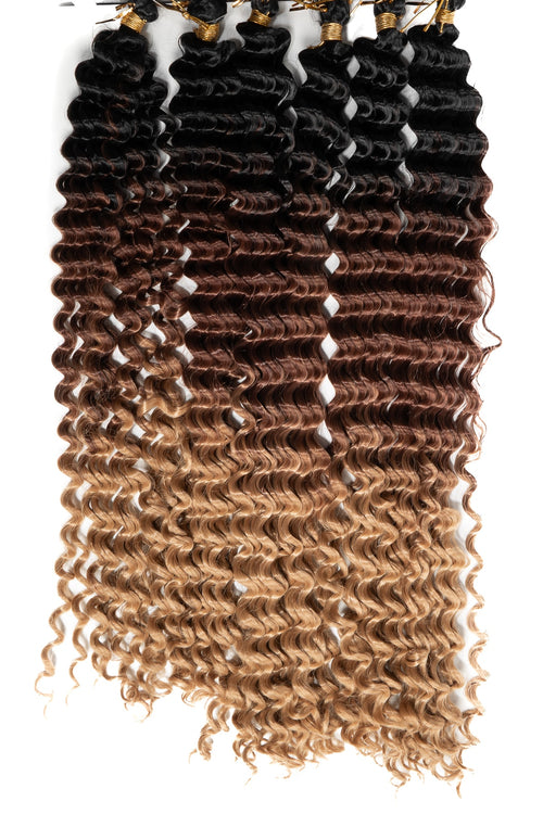 Boho lockar i vacker ombre från djup svart till gyllenblond. Täta spiralformade strån med mjuk textur.