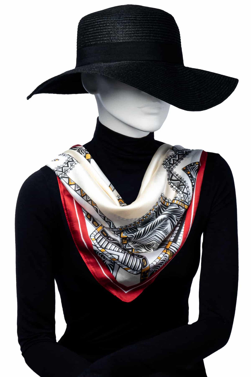 Elegant scarf med mönster i vitt, svart, guldgul och röd, hängande löst runt halsen.